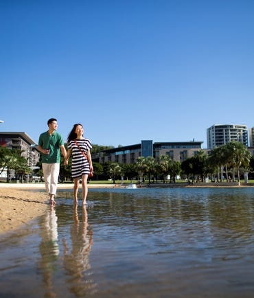 Couple walking along the lagoon at the Darwin Waterfront Precinct