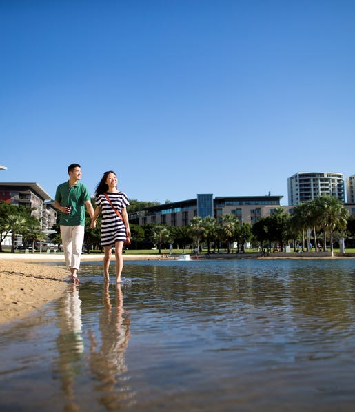 Couple walking along the lagoon at the Darwin Waterfront Precinct
