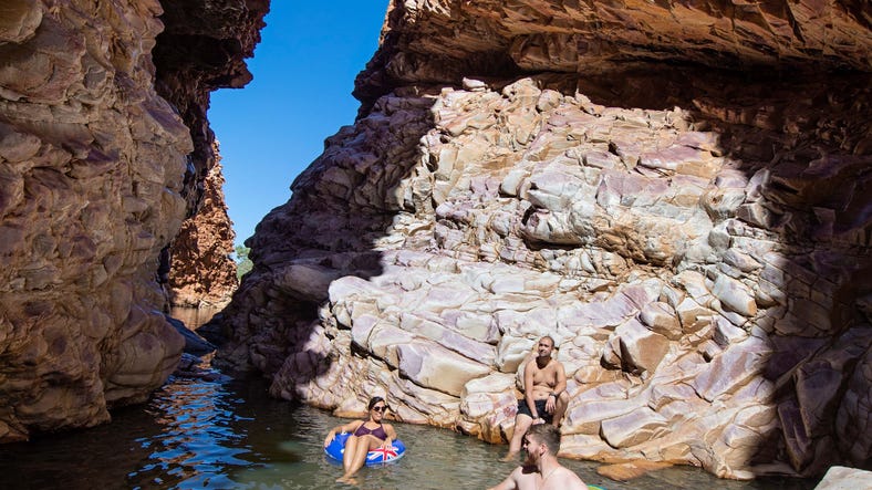 Friends floating through Redbank Gorge near Alice Springs