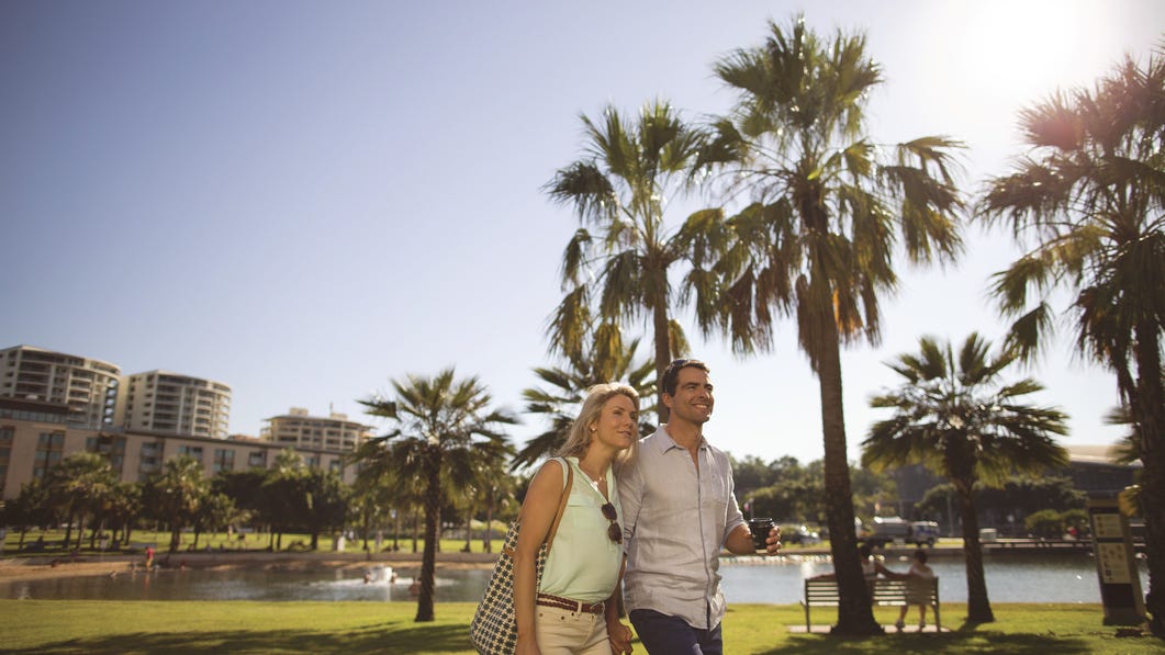 A couple walking at the Darwin Waterfront Lagoon