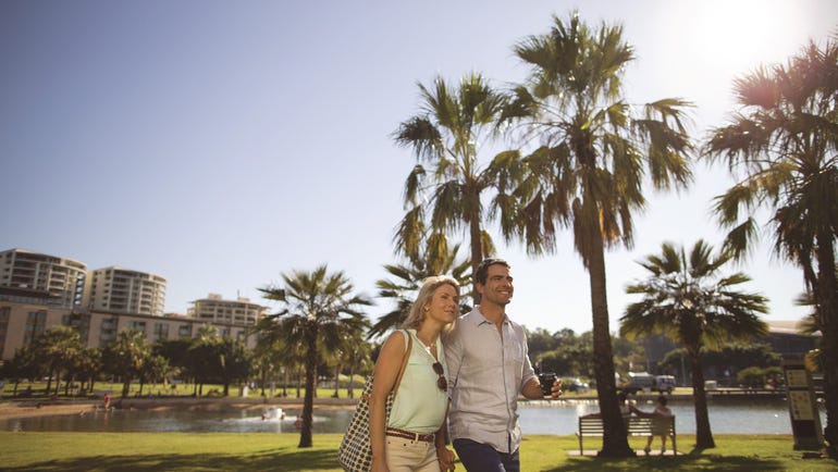 A couple walking at the Darwin Waterfront Lagoon