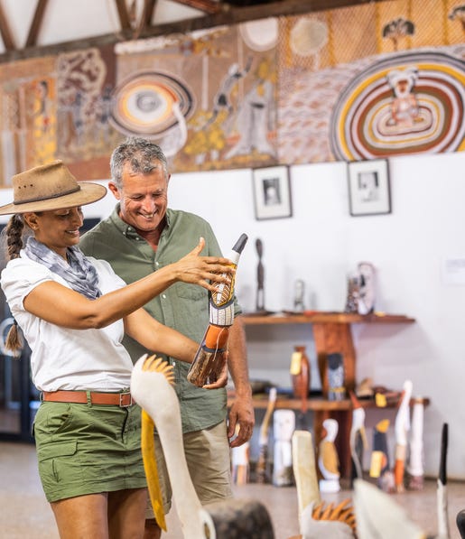 Two people looking at art