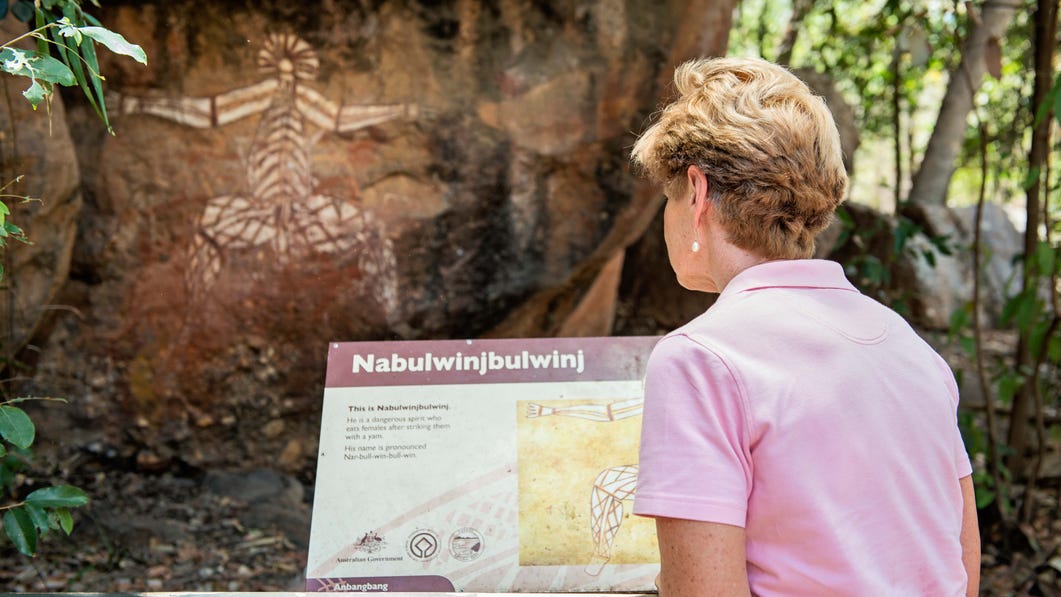 A lady looking at a Nourlangie Rock Art Site in Kakadu