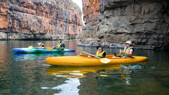 Family canoeing along Nitmiluk Gorge