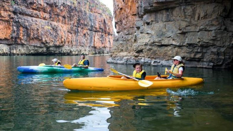 Family canoeing along Nitmiluk Gorge