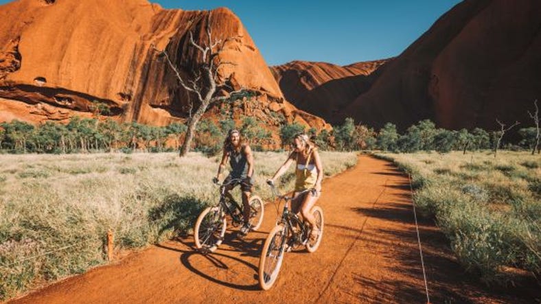 Couple riding bicycles at uluru.jpg