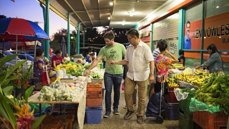 Local chef Jimmy Shu walking through Rapid Creek Markets