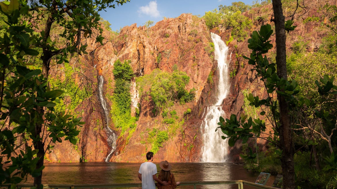 Couple looking up at waterfall