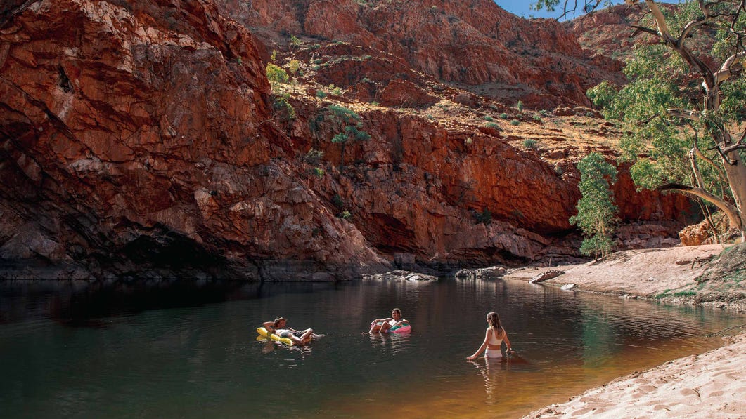 Group of friends swimming at Ormiston Gorge