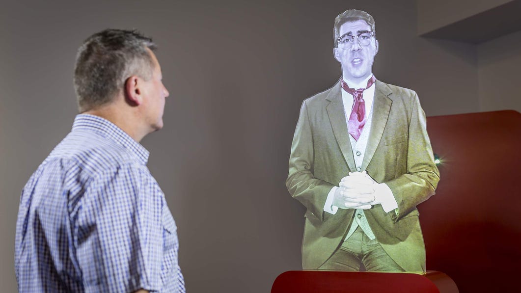 A visitor listening to a hologram display at the Royal Flying Doctor Service