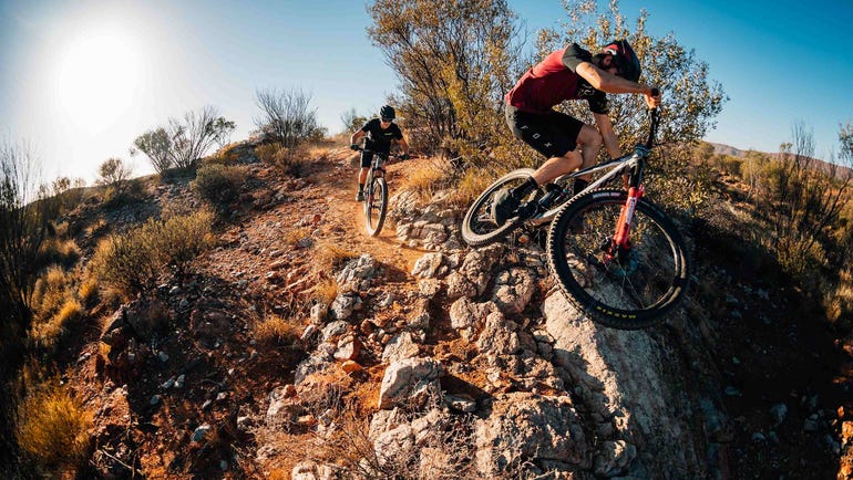 Wide action shot of a mountain biker riding in Alice Springs