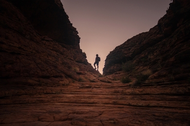 man walking through kings canyon