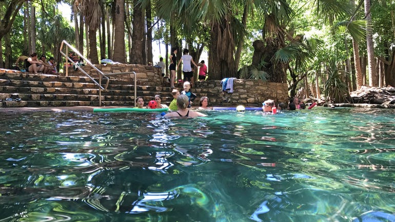 Families enjoyiong a swim at Mataranka Thermal Pool near Katherine