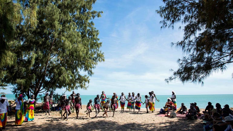 Group of Lirrwi dancers performing together on a beach in Arnhem Land