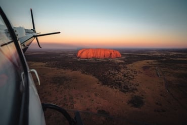 Shot of glowing Uluru out of a flying helicopter