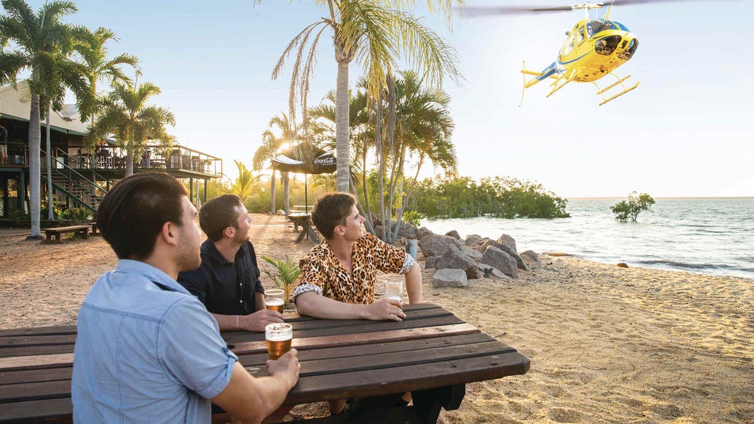 Group of freinds enjoying a drink at the Crab Claw Resort on a heli pub tour