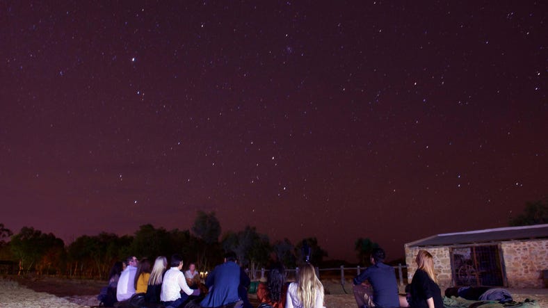 A group of people stargazing in alice springs