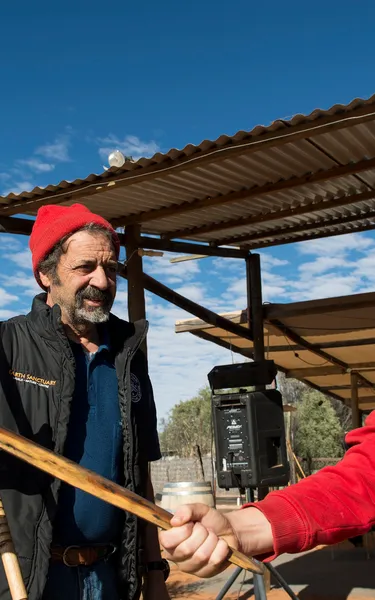 Kid holding a boomerang at Earth Sanctuary with a tour guide by his side