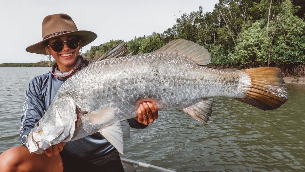 Woman-with-landed-barramundi