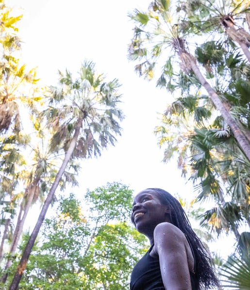 Woman walking under the palms