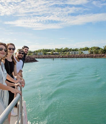 Group of people looking off the rail on the sealink Darwin Harbour Sightseeing Cruise