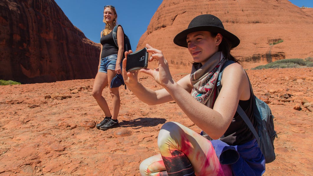 Friends taking pictures on a hike at Kata Tjuta