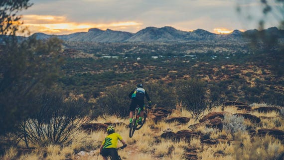 Two mountain bikers taking in views near Alice Springs