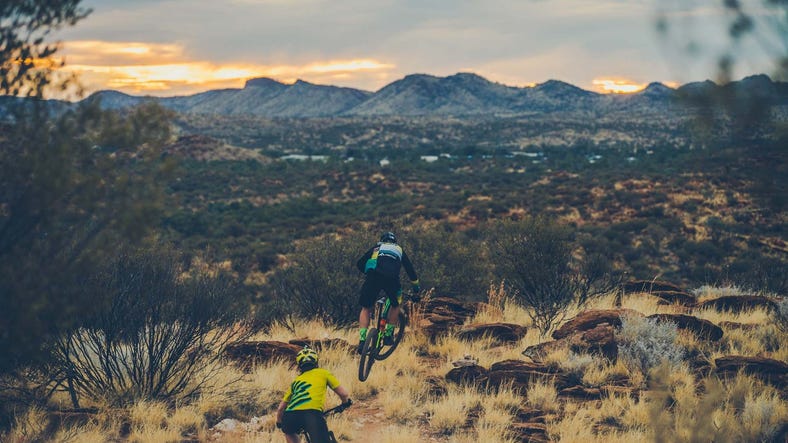 Two mountain bikers taking in views near Alice Springs