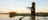 Man stand on the front of a boat casting a fishing rod on Yellow Water Billabong