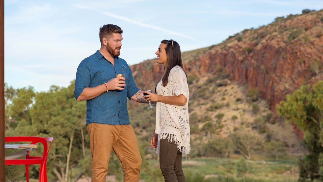A couple enjoying a wine at Glen Helen Resort