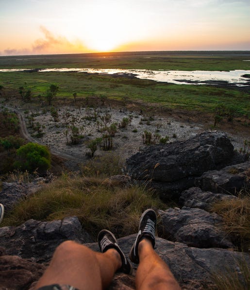 The sun setting over the wetlands from the point of view of someone sitting at Ubirr