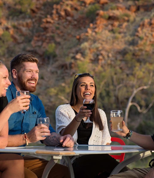 Friends having a drink at Glen Helen Gorge