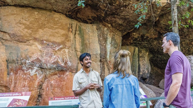 Two people listening to tour guide