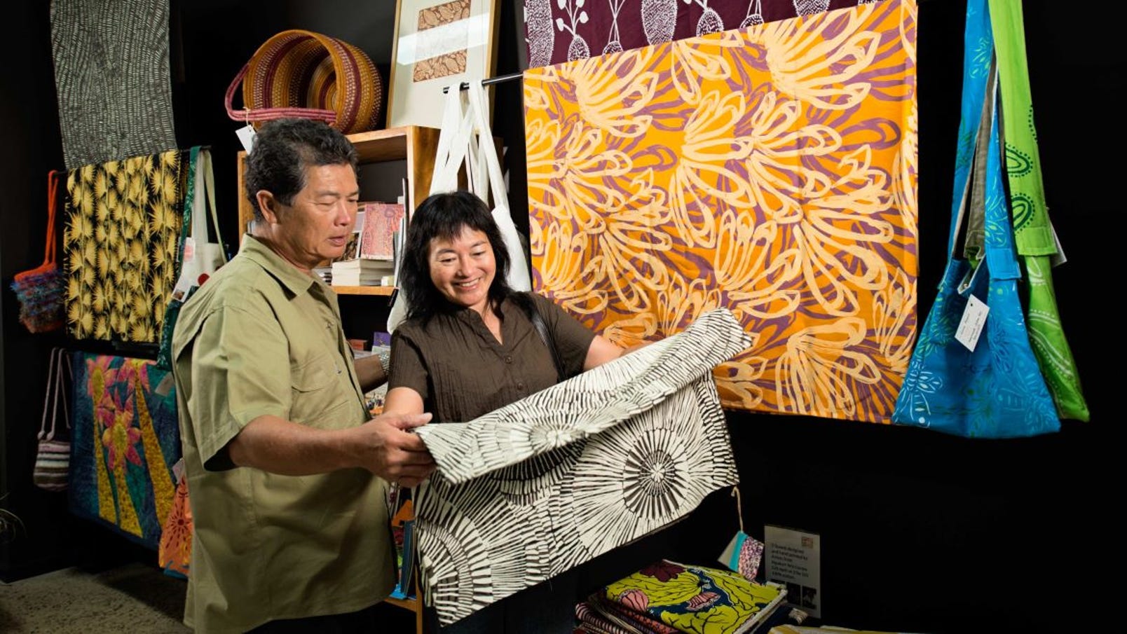 Couple reviewing art at Godinymayin Yijard Rivers Art and culture centre in Katherine