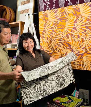 Couple reviewing art at Godinymayin Yijard Rivers Art and culture centre in Katherine