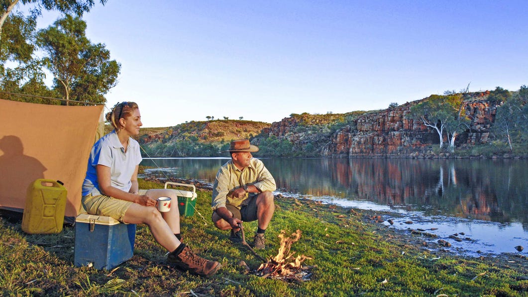 Two people sitting by a campfire at the Davenport ranges near Katherine
