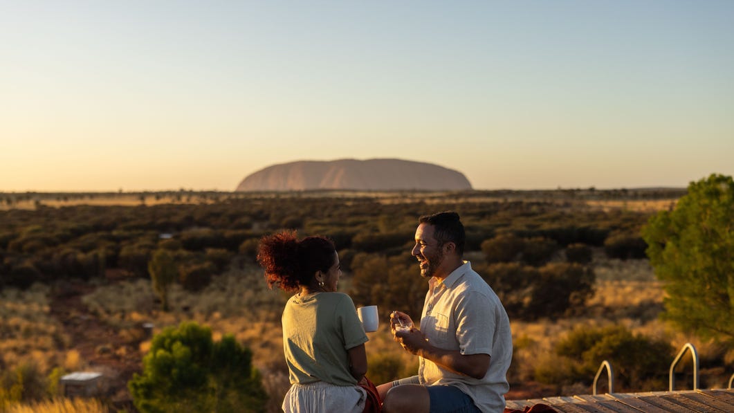 couple at uluru during sunrise