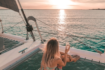 girl watching sunset on boat