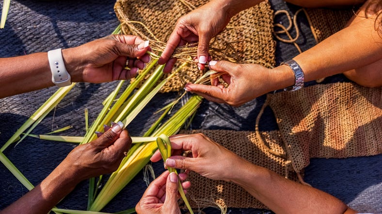 Three people weaving