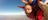 A man tandem skydiving above Uluru