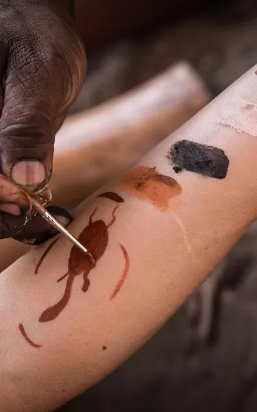 Woman having her hand painted by an Aboriginal Tour Guide at Pudakul Aboriginal Cultural Tours