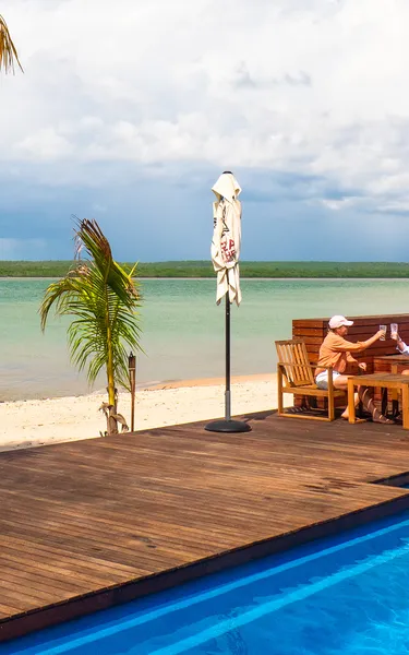 two women relaxing and having a refreshing drink on a deck at tiwi island retreat,-d-,jpg