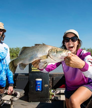 A lady holds a Barramundi caught at Shady Camp Billabong