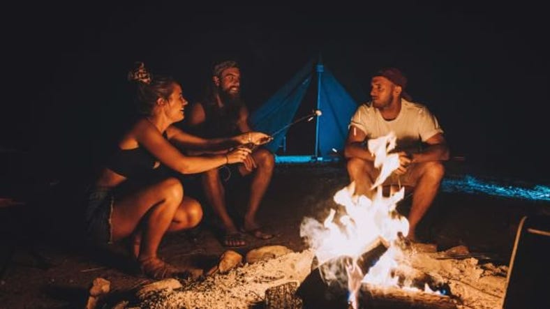 three friends roasting marshmallows over a campfire while camping at glen helen.jpg