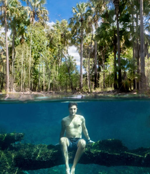 Man sitting underwater Elsey National Park near Kathereine