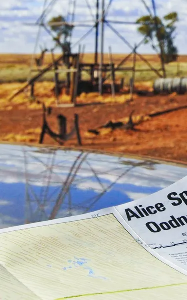 Person holding a map of Alice Springs to Oodnadatta