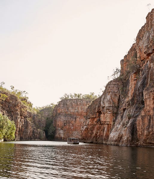 boat going through nitmiluk gorge next to the large cliffs,-d-,jpg